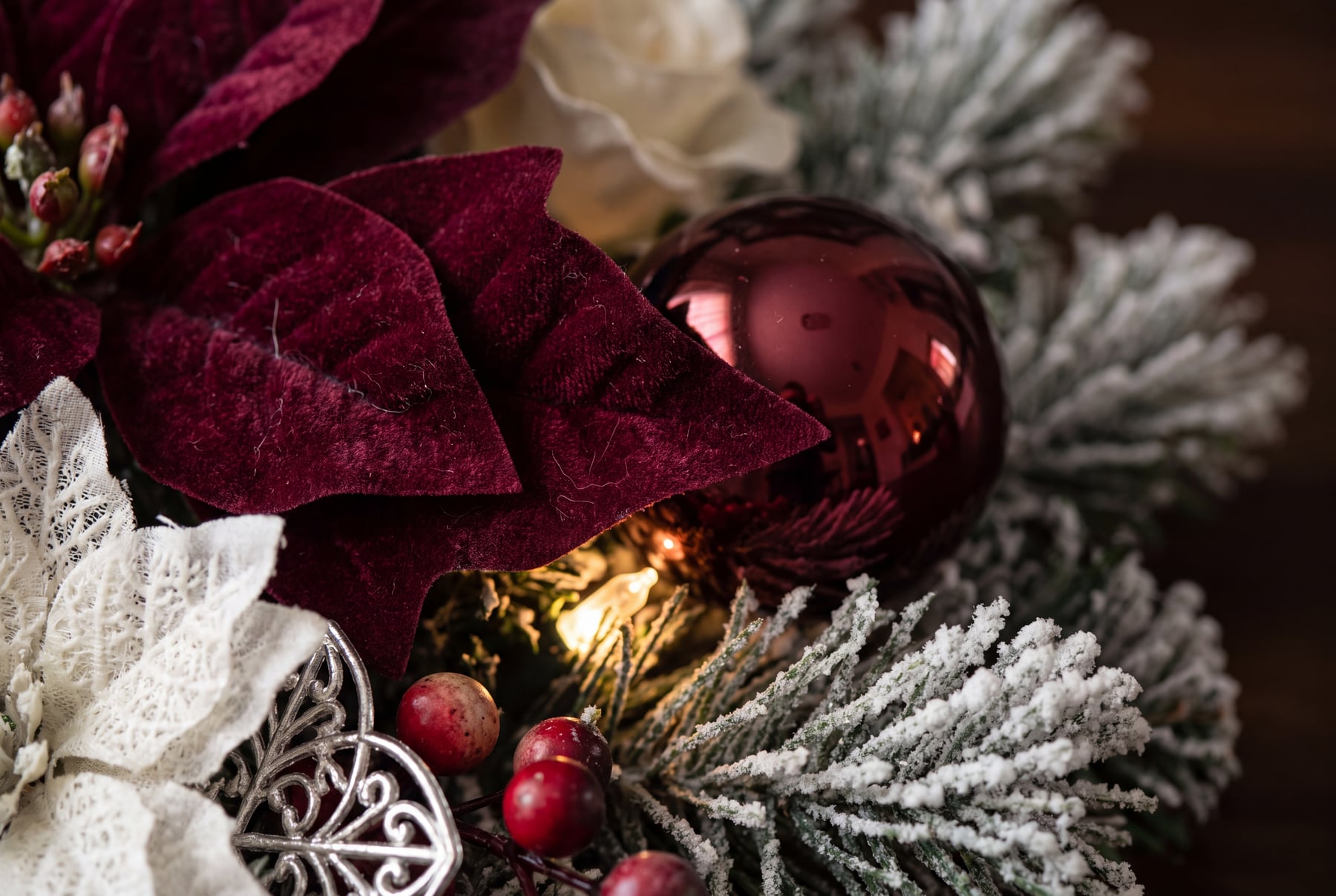 White lace, burgundy velvet, and berries on the flocked branch.